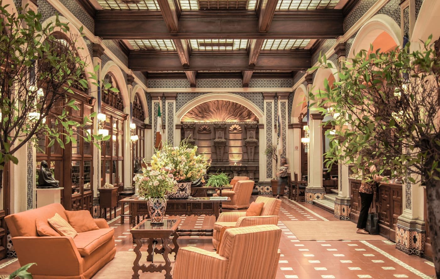 Grand hotel lobby with chandelier and marble floors
